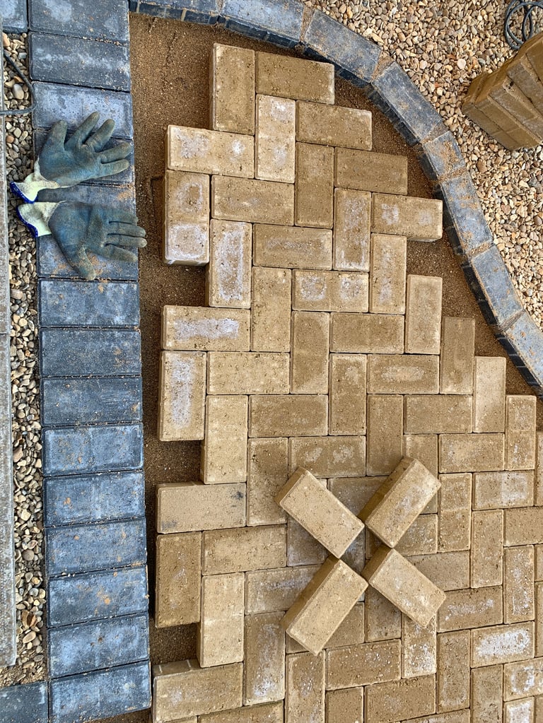 Construction of block paving to a front driveway in charcoal grey and buff blocks